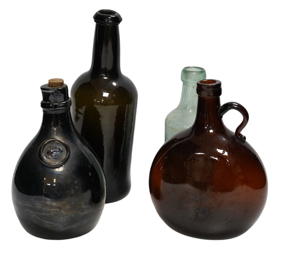 A Georgian wine bottle and three others including one bearing label reading ‘J.G. MONNET & Co. COGNAC’, tallest 27cm. Condition - commensurate with age